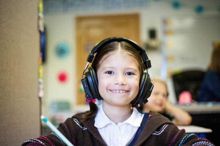 Young girl wearing headphones in a classroom