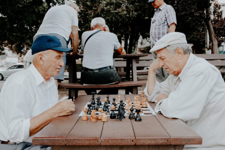 Elderly men playing chess at the park